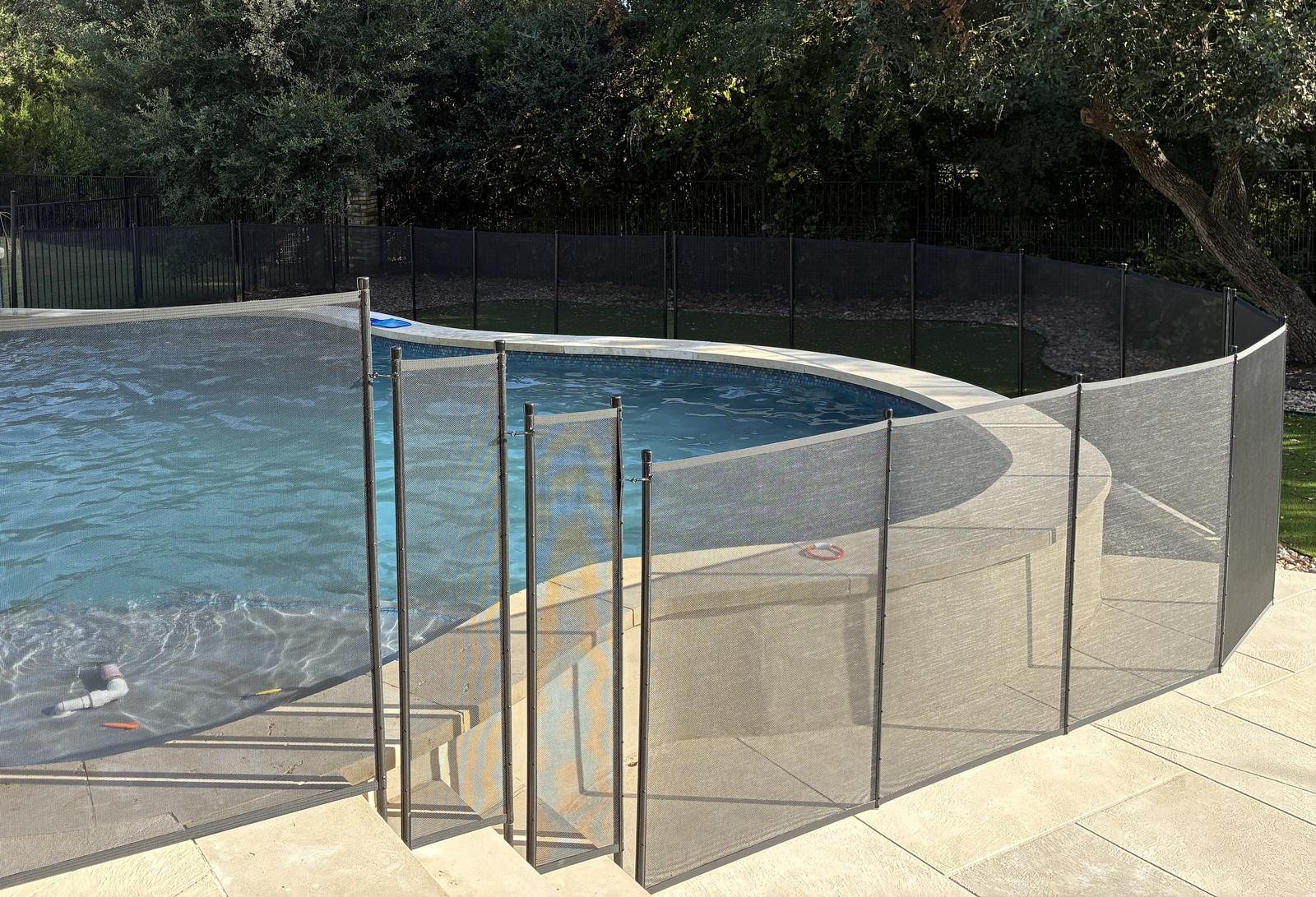 Removable mesh pool fence with a self-closing safety gate around a backyard pool in the greater Austin area, All-Safe certified