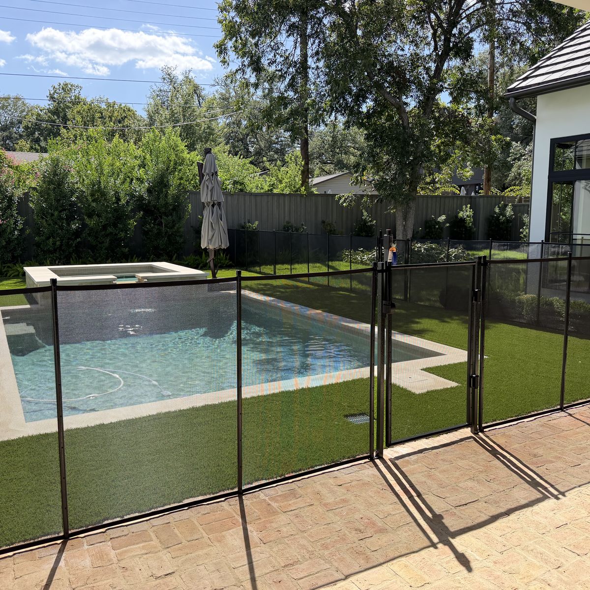 Removable mesh pool fence with a self-closing safety gate beside a pool in the Allandale neighborhood of Austin TX, All-Safe certified