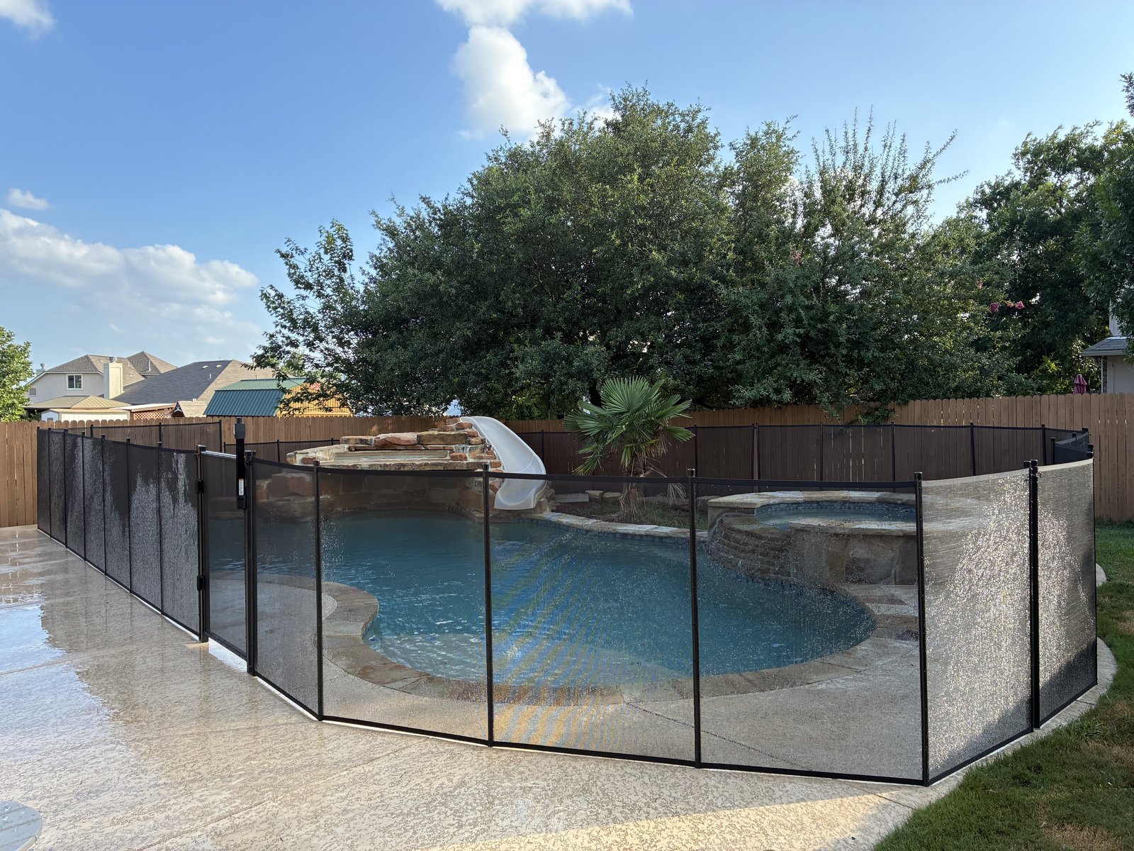 Removable mesh pool fence installation around a freeform pool and spa in Leander TX, All-Safe certified